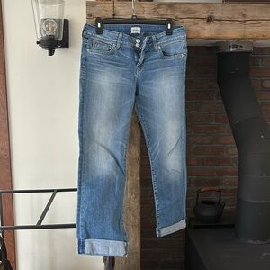 Hudson premium stretch fabric, Midrise medwash, signature button-flap pockets.